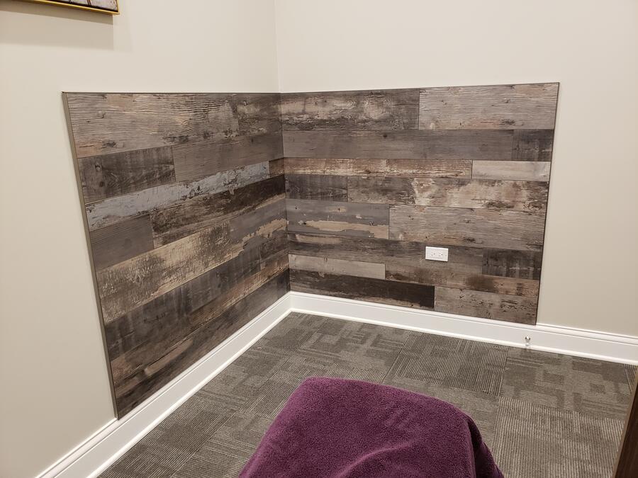 Reclaimed-wood accent wall in a finished treatment room