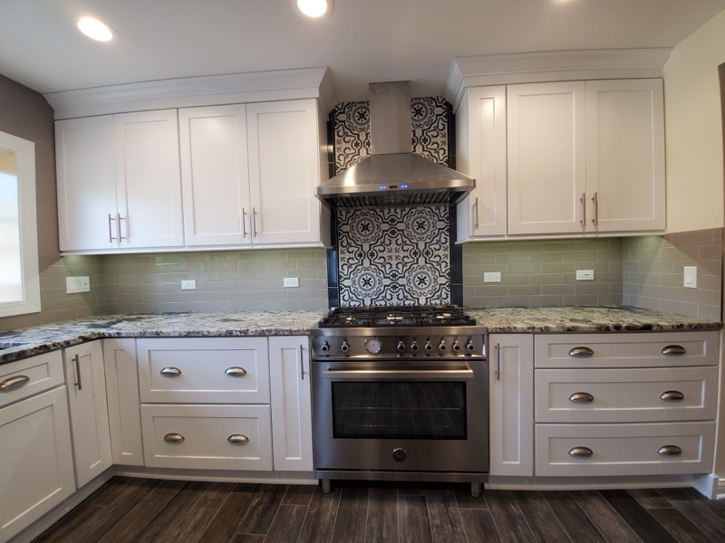 Granite countertop and hardwood flooring in remodeled kitchen